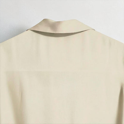 OnenessU minimalist short-sleeve blouse in a soft yellow-base cream tone with a refined collar and recycled fabric.